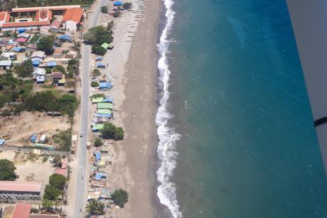 An aerial view of a beach and residential area