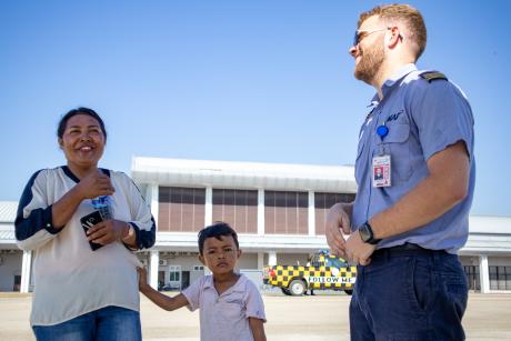 A pilot talks to passengers at the airport
