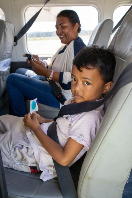 A boy and his mother on a small plane