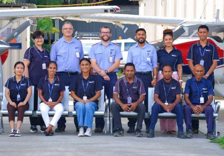 A team photo of staff in a hangar