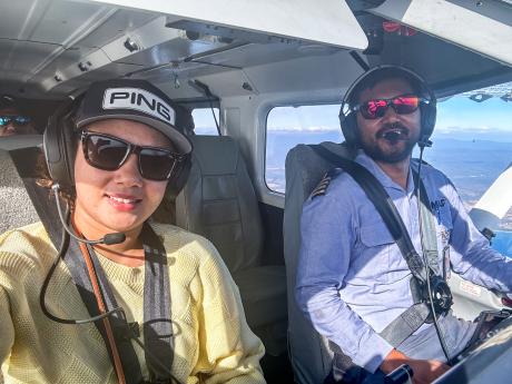 A pilot in the cockpit with his wife in the front seat