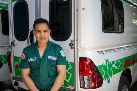 A medic stands next to an ambulance